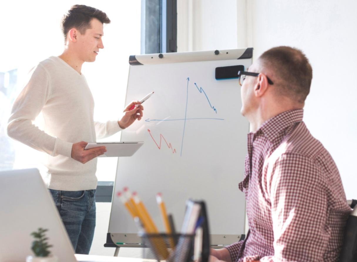 Modern office workspace with financial planning materials and comfortable consultation area